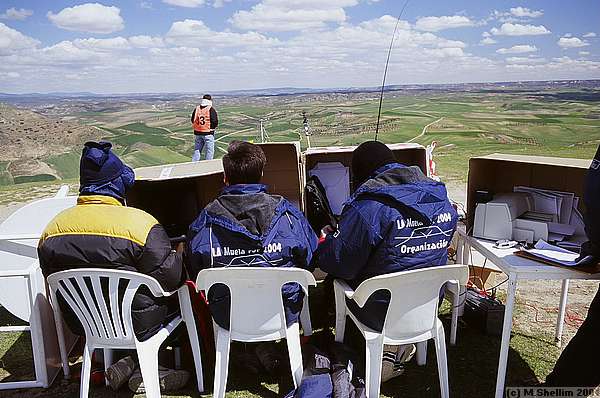 Scorers sheltering from cold behind their computers.