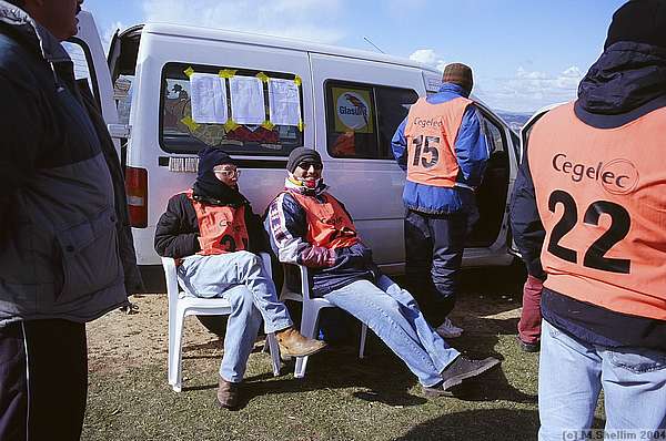 Sheltering by the van.