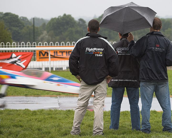 CPLR's machine streaks by as an umbrella shields his Tx