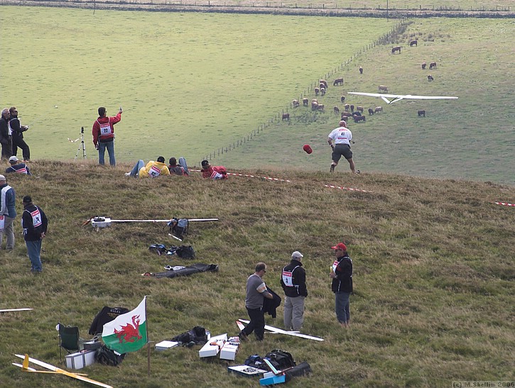 Tim Cone launching. The pilot is on extreme left. Note bod with wind meter.