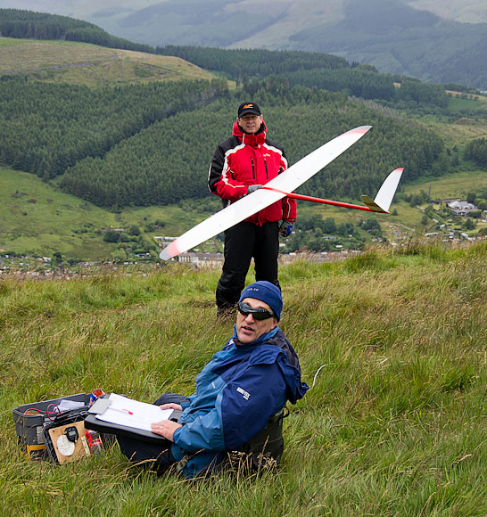 Andrzej looks back to check the wind direction as Frank Hulton waits